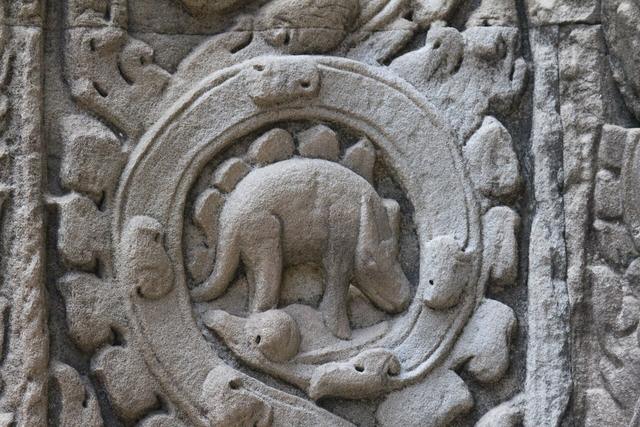 Stone roundel at Ta Prohm showing a four-legged animal with rounded shapes along its back